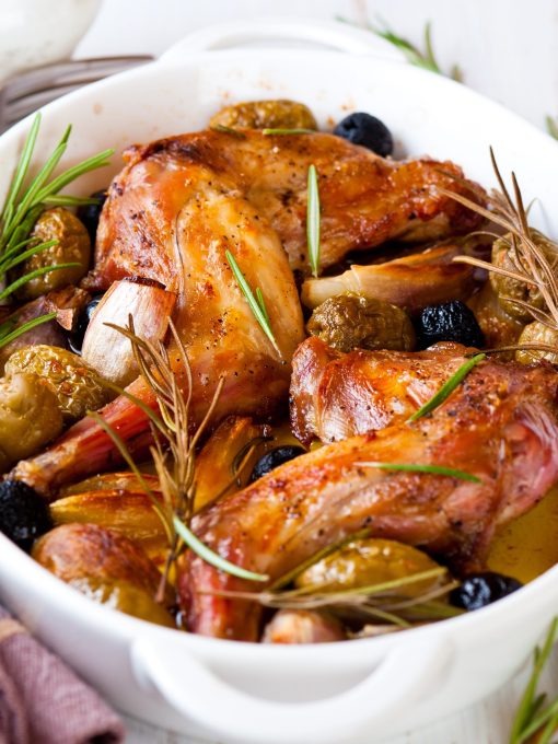Oven baked rabbit legs with olives and rosemary